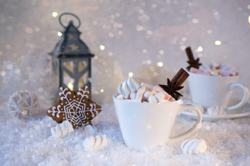 Wall Mural - Blurred background of winter frost and Christmas chocolate spice beverage with cookies in white cups