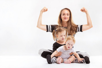 Portrait of healthy family of mother rising hands and playing children isolated at white background.