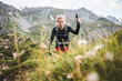 Adventurous Sportive Girl hiking in Beautiful Alpine Mountains