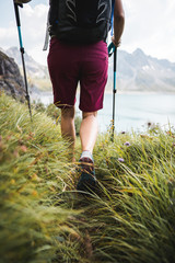 Wall Mural - adventurous sportive girl hiking at a lake in beautiful alpine mountains