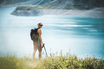 Wall Mural - adventurous sportive girl hiking at a lake in beautiful alpine mountains