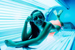 © mnelen.com - slender sexy dark-haired girl sunbathing under ultraviolet rays in goggles, smiling