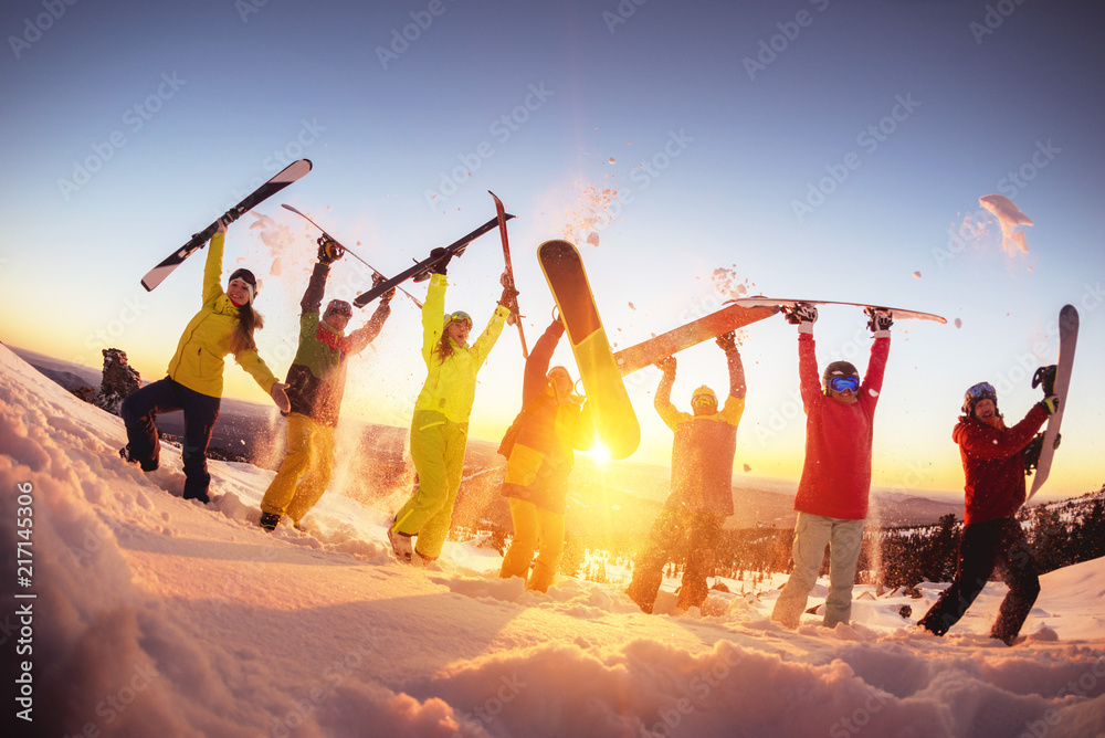 Happy friends at ski resort having fun sunset - obrazy, fototapety, plakaty 