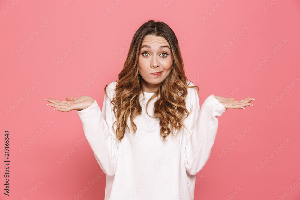 Portrait of a confused young casual girl shrugging - obrazy, fototapety, plakaty 