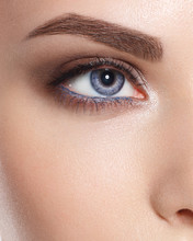 Close Up Of Blue Woman Eye With Beautiful Brown With Red And Orange Shades Smokey Eyes Makeup. Modern Fashion Make Up. Good Vision, Contact Lenses, Brow Bar Or Fashion Eyebrow Makeup Concept