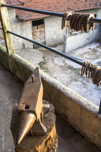 Fotografie, Obraz Anvil and horseshoes on an altarpiece in the neighborhood of Parelheiros, south zone of Sao Paulo, SP