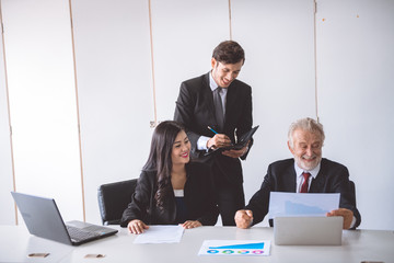 Senior businessman discussing work with his team.