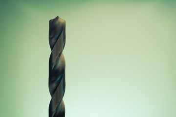 Poster - Metal drill bit rotation on a dark background. Macro view.