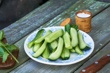 Canvas Print - Slices of fresh cucumbers with salt on a plate