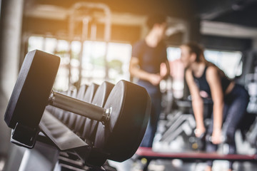 Cinematic tone of young attractive fitness woman exercise with machine in gym. 