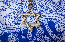 A Star Of David, Famous Jewish Hexagram Symbol, On A Blue And White Background.