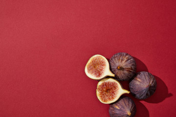 Poster - top view of fresh ripe healthy figs on red background