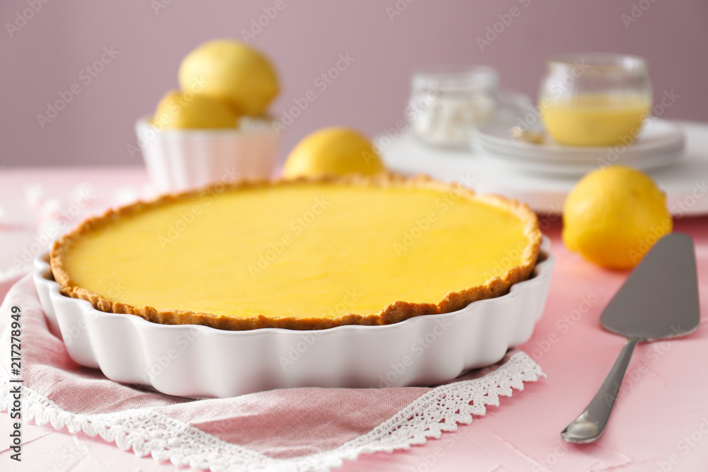 Tasty lemon pie on table