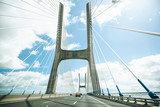 Unusual or original view of the Vasco da Gamma Bridge in Lisbon in Portugal. The bridge is moving vehicles or cars.