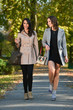 © dobok - two young fashion woman waling in a park in autumn