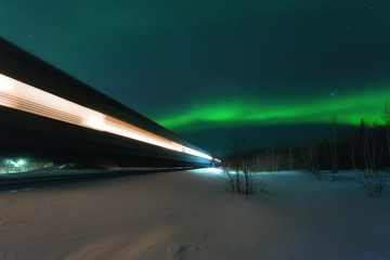 walking train and aurora borealis over the tundra
