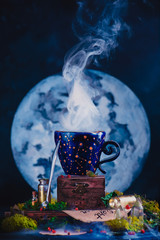 Wall Mural - Astronomy or astrology still life with Moon, crystals, moss and potion bottles. Ceramic cup with constellations in a witch or wizard workplace. Magic concept with copy space