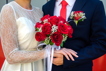 Young couple in love celebrating a wedding, the newlyweds are holding hands.