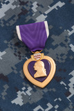 Fototapeta  - Purple Heart War Medal on Navy Camouflage Material