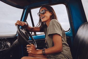 Woman on road trip having fun driving a car