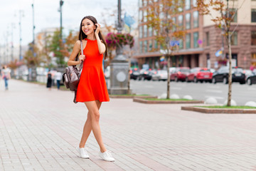 Sticker - Full-size portrait of beautiful in a red dress and with a backpa