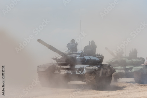 Tela Military or army tank ready to attack and moving over a deserted battle field terrain