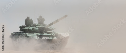 Papel de parede Military or army tank ready to attack and moving over a deserted battle field terrain