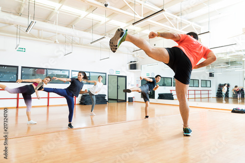 Fotografía Instructor And Clients Kickboxing In Dance Class At Gym