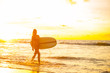 © Mikalai Bachkou - Young fit surfer girl in sexy red bikini with blank surfing longboard walk from water at sunset ocean. Modern family lifestyle, people water sport adventure camp and extreme swim on summer vacation.