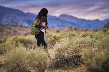 fit african american woman hiking through alabama hills park in california