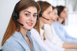 © rogerphoto - Call center. Beautiful cheerful smiling operator consulting clients with headset. Business concept of customer service