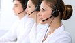 © rogerphoto - Call center. Focus on beautiful woman in headset