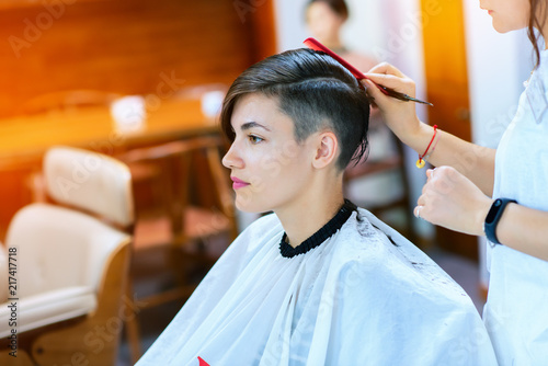 Young Woman And Hairdresser Cuting Hair At Hairdressing Salon