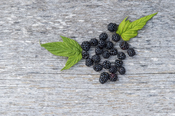 blackberry with leaves on old wooden background