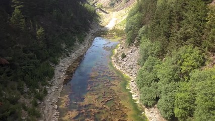 Wall Mural - aerial drone view flying over a narrow lake located in a long, narrow canyon in wales