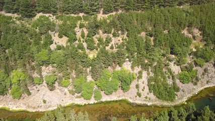 Wall Mural - aerial drone view flying sideways over a long, narrow lake located in a small canyon