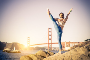 Woman doing yoga on the beach