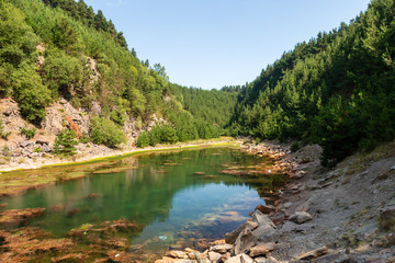 Wall Mural - beautiful lake in a small canyon surrounded by forest and woodland (blaencuffin, wales)