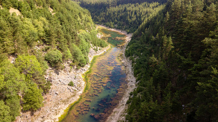 Wall Mural - aerial drone view of a beautiful shallow lake located in a narrow gorge surrounded by woodland and c