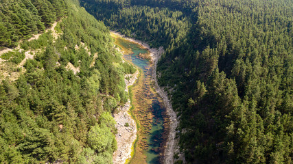 Wall Mural - aerial drone view of a beautiful shallow lake located in a narrow gorge surrounded by woodland and c