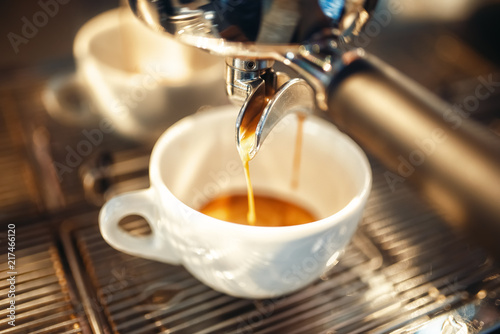 Fotomural Coffee machine pours foam into the cup closeup