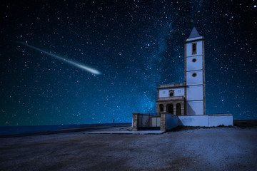 perseid meteor shower and the milky way over castle over church