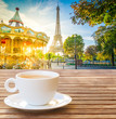 cup of coffee with view of Eiffel Tower with merry go round from Trocadero at sunrise, Paris, France