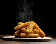 © Dmitry Lobanov - Delicious breaded mozzarella cheese sticks stack with hand with hot smokes
