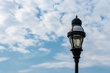 Street light isolated against cloudy blue sky background 