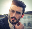 © starsstudio - Handsome serious businessman standing outside in elegant European city center, Turin in Italy