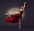 © Sofia Zhuravetc - Ballerina. Young graceful woman ballet dancer, dressed in professional outfit, shoes and red weightless skirt is demonstrating dancing skill. Beauty of classic ballet dance.