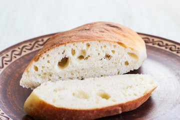 Sliced homemade bread on a ceramic dish. Bread for breakfast.