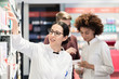 © Kzenon - Portrait of a female experienced pharmacist reading the indications from the package of a new pharmaceutical product during work in a contemporary drugstore