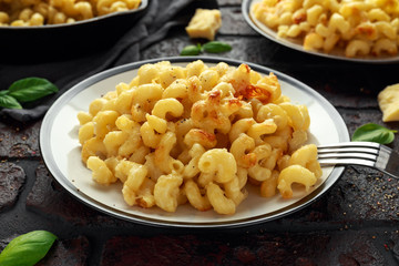 Homemade baked macaroni and cheese with cheddar served on plate